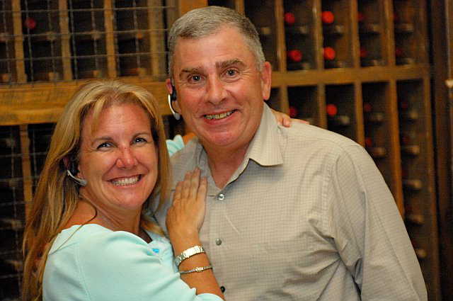 Debbie Hubaud-Bukosky (Plantronics) and General John Abizaid, doth wearing Plantronics Voyager Headsets